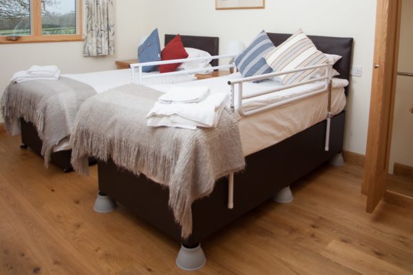 Elephants feet to raise the beds with bed rails all available at Wallops Wood Cottages