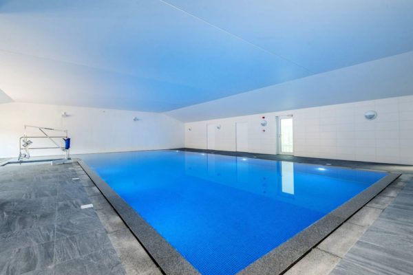 indoor swimming pool blue water lifting hoist
