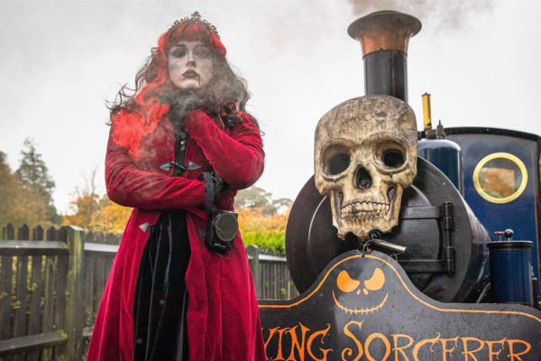 The Halloween Ghost Train named the Flying Sorcerer with vampire dressed in black and red at Exbury Gardens