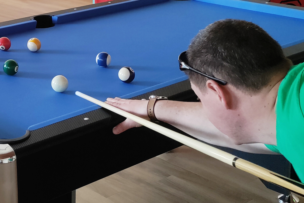 Enjoying a game of pool in the games room